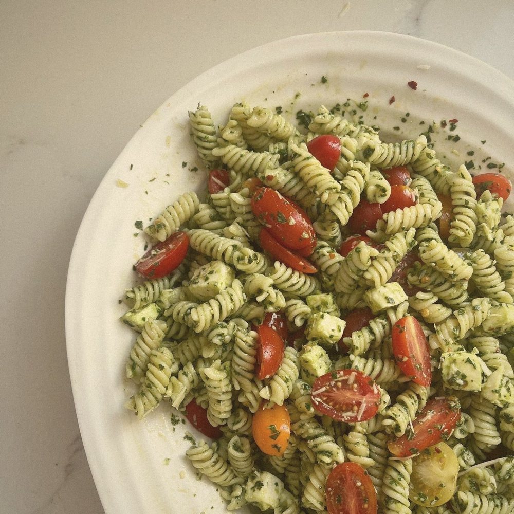 Pesto pasta salad with cherry tomatoes and mozzarella